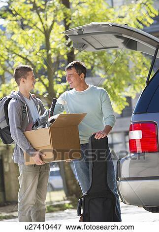 Father helping teenage son (16-17) packing to college View Large Photo Image Stock Photo - Father helping teenage son (16-17) packing to college. Fotosearch