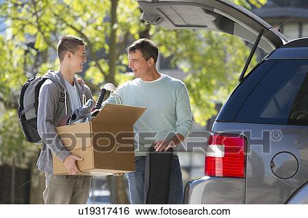 Father helping teenage son (16-17) packing to college View Large Photo Image Stock Photograph - Father helping teenage son (16-17) packing to college. Fotosearch