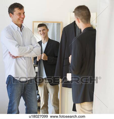 Father with teenage (16-17) son buying suit View Large Photo Image Stock Photo - Father with teenage (16-17) son buying suit. Fotosearch