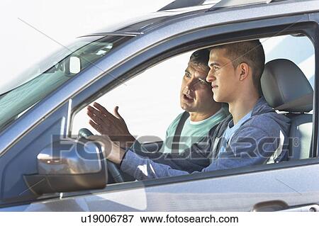 Father with teenage (16-17) son driving View Large Photo Image Stock Photo - Father with teenage (16-17) son driving. Fotosearch