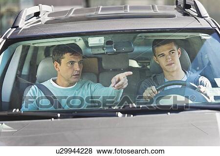 Stock Photo - Father with teenage (16-17) son driving. Fotosearch