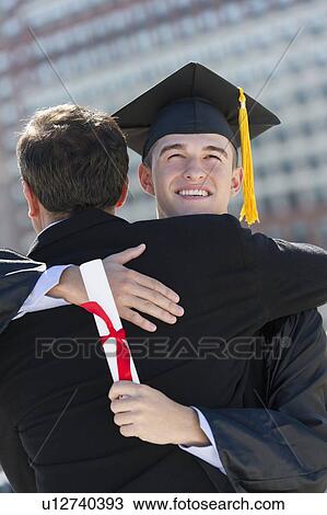 Father with teenage sun (16-17) at graduation ceremony View Large Photo Image Stock Image - Father with teenage sun (16-17) at graduation ceremony. Fotosearch
