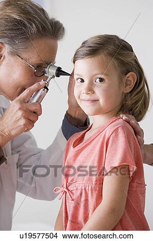Picture - Female doctor examining girl (4-5). Fotosearch
