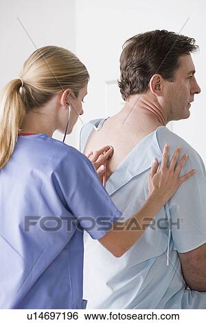 Female doctor examining patient with stethoscope View Large Photo Image Stock Photograph - Female doctor examining patient with stethoscope. Fotosearch
