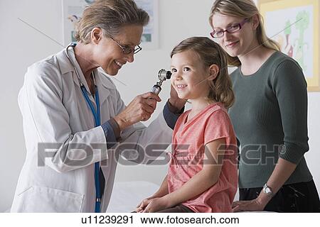 Female doctor examining small girl (4-5) View Large Photo Image Stock Image - Female doctor examining small girl (4-5). Fotosearch