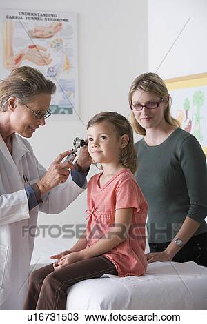 Stock Image - Female doctor examining small girl (4-5). Fotosearch