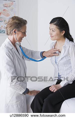 Female doctor examining woman View Large Photo Image Stock Image - Female doctor examining woman. Fotosearch