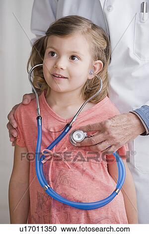Female doctor with girl (4-5) listening to stethoscope View Large Photo Image Stock Image - Female doctor with girl (4-5) listening to stethoscope. Fotosearch