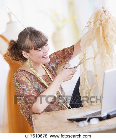 Female fashion designer working in studio View Large Photo Image Stock Photo - Female fashion designer working in studio. Fotosearch
