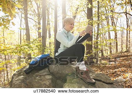 Female hiker using digital tablet in forest View Large Photo Image Stock Image - Female hiker using digital tablet in forest. Fotosearch