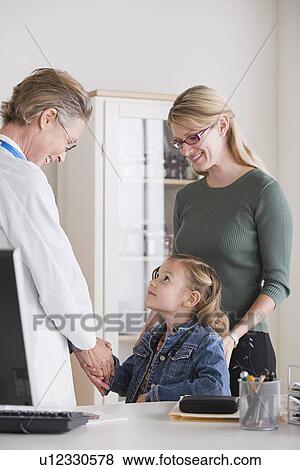 Female shaking hand with small girl (4-5) in her office View Large Photo Image Stock Photo - Female shaking hand with small girl (4-5) in her office. Fotosearch