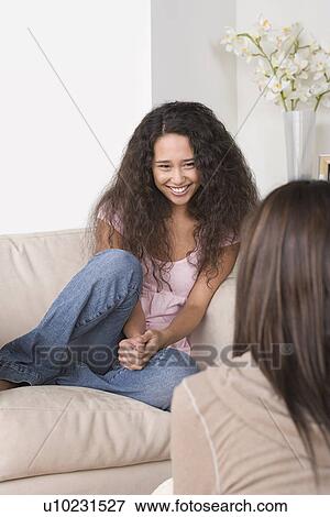 Friends relaxing at home View Large Photo Image Stock Photo - Friends relaxing at home. Fotosearch