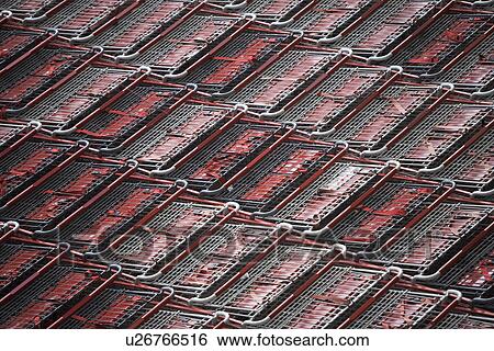 Stock Photograph - Full frame shot of supermarket trolleys. Fotosearch