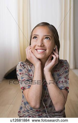 Girl 10-11) listening music on headphones View Large Photo Image Picture - Girl 10-11) listening music on headphones. Fotosearch