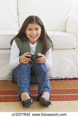 Girl (10-11) playing video games View Large Photo Image Stock Image - Girl (10-11) playing video games. Fotosearch