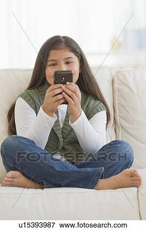 Stock Photo - Girl (10-11) using mobile phone. Fotosearch