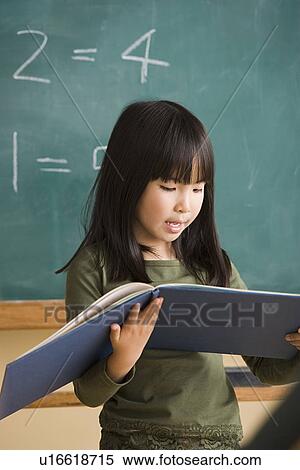 Girl (6-7) having presentation in classroom View Large Photo Image Stock Photography - Girl (6-7) having presentation in classroom. Fotosearch