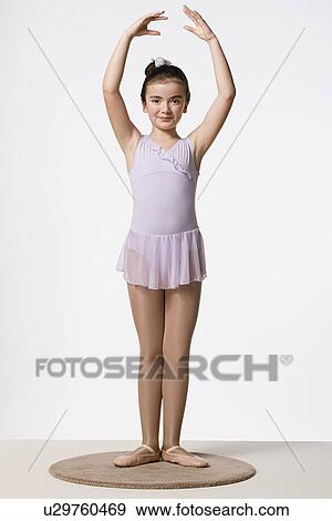 Girl (8-9) in tutu dress practicing ballet dancing, studio shot View Large Photo Image Stock Photo - Girl (8-9) in tutu dress practicing ballet dancing, studio shot. Fotosearch