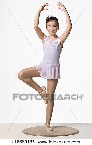 Girl (8-9) in tutu dress practicing ballet dancing, studio shot View Large Photo Image Stock Photography - Girl (8-9) in tutu dress practicing ballet dancing, studio shot. Fotosearch