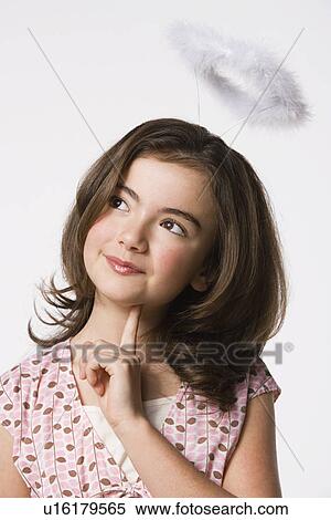 Stock Photography - Girl (8-9) wearing halo, studio shot. Fotosearch