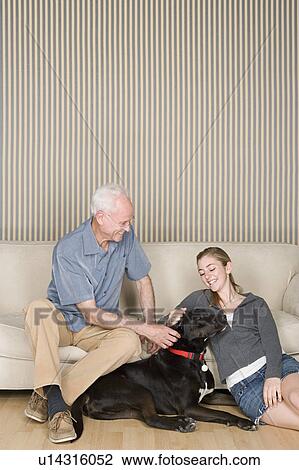 Grandfather with granddaughter (14-15) stroking dog View Large Photo Image Stock Image - Grandfather with granddaughter (14-15) stroking dog . Fotosearch