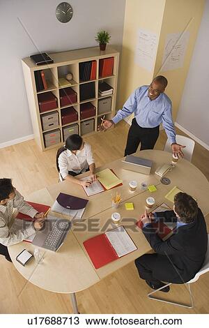 Stock Image - Group of businesspeople in meeting. Fotosearch