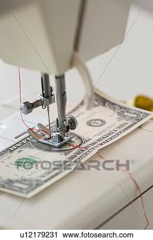 Halves of dollar bill being sewed with sewing machine View Large Photo Image Stock Image - Halves of dollar bill being sewed with sewing machine. Fotosearch