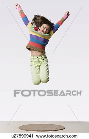 Happy girl (8-9) jumping, studio shot View Large Photo Image Stock Image - Happy girl (8-9) jumping, studio shot. Fotosearch