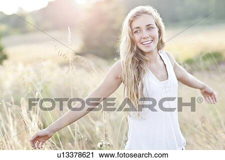 Happy teenage girl (16-17) enjoying bright sunshine View Large Photo Image Stock Image - Happy teenage girl (16-17) enjoying bright sunshine. Fotosearch