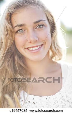 Stock Photography - Happy teenage girl (16-17) portrait. Fotosearch