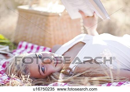 Stock Photography - Happy teenage girl (16-17) relaxing outdoors. Fotosearch