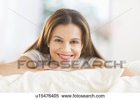 Happy woman lying on bed View Large Photo Image Stock Photography - Happy woman lying on bed. Fotosearch