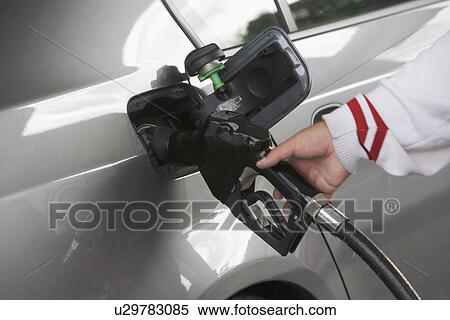 Human hand holding refueling pump View Large Photo Image Stock Photography - Human hand holding refueling pump. Fotosearch