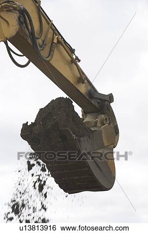 Low angle view of digger scoop full of soil View Large Photo Image Stock Photograph - Low angle view of digger scoop full of soil. Fotosearch