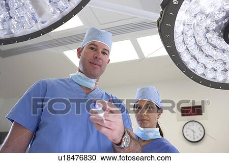 Male and female surgeons in operating room View Large Photo Image Stock Image - Male and female surgeons in operating room. Fotosearch