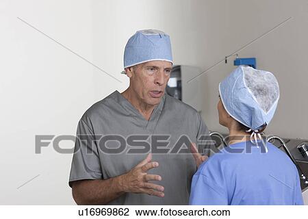 Male and female surgeons talking View Large Photo Image Stock Image - Male and female surgeons talking. Fotosearch