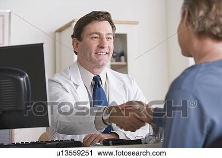 Male doctor shaking hand with patient View Large Photo Image Stock Image - Male doctor shaking hand with patient. Fotosearch