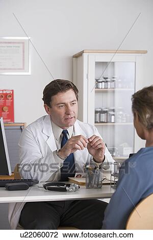 Male doctor talking to patient View Large Photo Image Stock Image - Male doctor talking to patient. Fotosearch