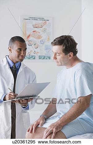 Male doctor talking to patient View Large Photo Image Stock Photography - Male doctor talking to patient. Fotosearch
