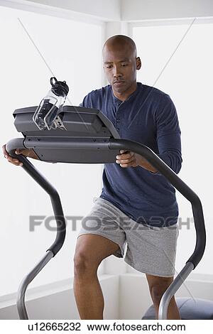 Man exercising on treadmill View Large Photo Image Stock Image - Man exercising on treadmill. Fotosearch
