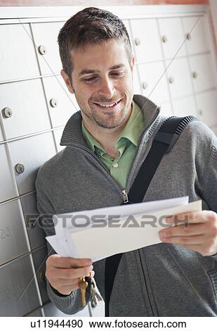 Man looking at correspondence View Large Photo Image Stock Image - Man looking at correspondence. Fotosearch