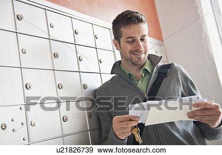 Man looking at correspondence View Large Photo Image Stock Photo - Man looking at correspondence. Fotosearch