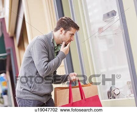 Man looking at window display View Large Photo Image Stock Image - Man looking at window display. Fotosearch