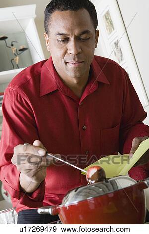 Stock Photo - Man preparing dessert. Fotosearch