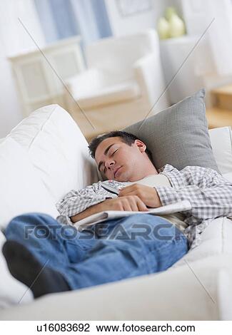 Man resting on sofa View Large Photo Image Stock Image - Man resting on sofa. Fotosearch
