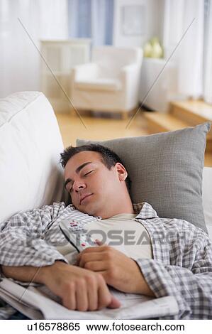 Stock Photography - Man resting on sofa. Fotosearch
