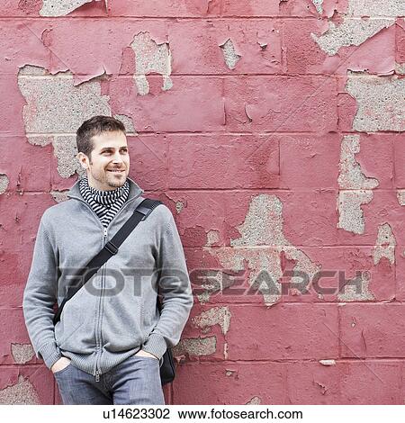 Man standing at front of old peeling red wall View Large Photo Image Stock Image - Man standing at front of old peeling red wall. Fotosearch