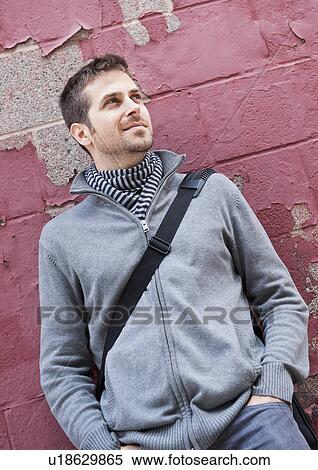 Man standing at front of old peeling red wall View Large Photo Image Stock Photography - Man standing at front of old peeling red wall. Fotosearch