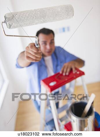 Man standing on ladder with paint roller View Large Photo Image Stock Image - Man standing on ladder with paint roller. Fotosearch