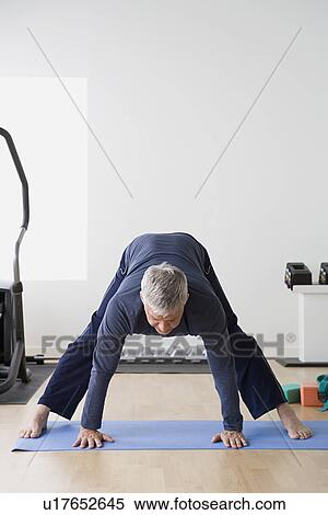 Man stretching in gym View Large Photo Image Stock Photography - Man stretching in gym. Fotosearch